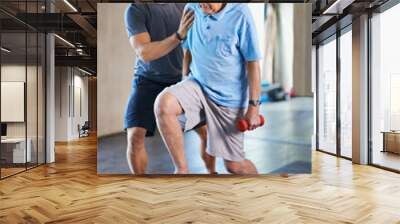 Its not easy, I know. Cropped shot of a handsome personal trainer with a senior man. Wall mural