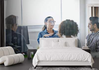 Meeting with the project group. Cropped shot of four young designers having a business meeting. Wall mural