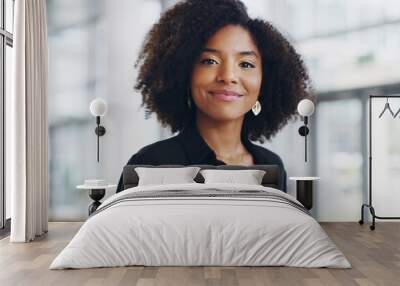 Success is mine for the taking. Cropped shot of a confident young businesswoman walking through a modern office. Wall mural