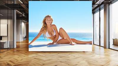 The perfect outfit for perfect weather. Shot of an attractive young woman in a bikini outdoors. Wall mural