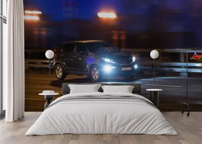 SUV rides at night on the highway Wall mural