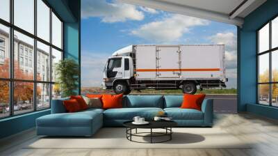 Truck Drives Suburban Highway Sunny Day Wall mural