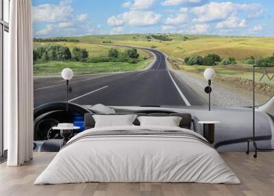 View from the windshield of a car driving along a sunset road Wall mural