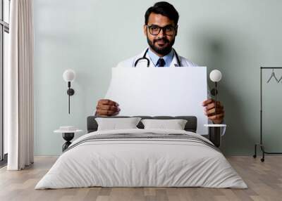 a man in a lab coat holds up a piece of paper. Wall mural