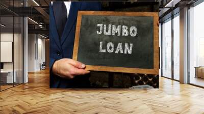 Business concept about JUMBO LOAN with sign on chalkboard in hand. Wall mural