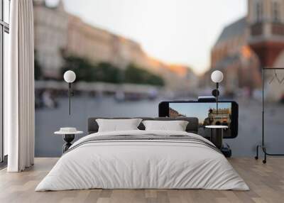 Close-up smartphone take cityscape photo and video timelapse on tripod.  Wall mural