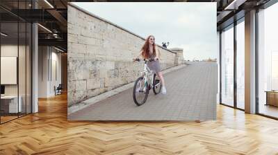 Beautiful woman riding on bike Wall mural