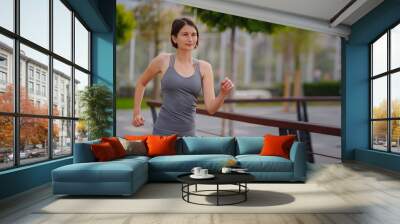 outdoor sports, workout and wellness concept. asian young strong, confident woman in sportive clothes in green park. Wall mural