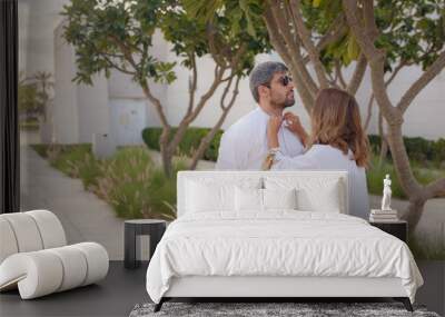 Travel to the United Arab Emirates, Abu Dhabi. Arab couple visiting park near Grand Mosque in Abu Dhabi wearing traditional dress. Wall mural