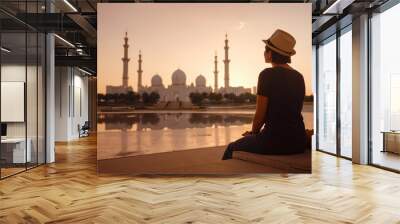 travel to the United Arab Emirates, Happy young asian female traveler with backpack and hat in Wahat Al Karama or Oasis of Dignity, permanent memorial for its martyrs, and Shaikh Zayed Grand Mosque. Wall mural