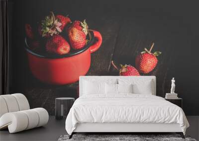 Strawberries in an iron mug on a wooden table. Wall mural