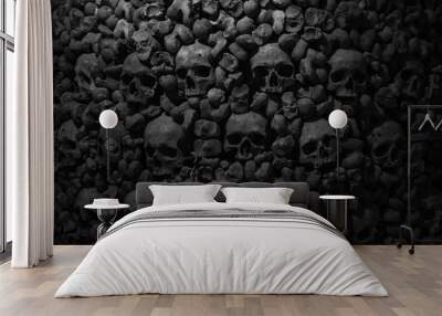 Collection of skulls and bones covered with spider web and dust in the catacombs. Numerous creepy skulls in the dark. Abstract concept symbolizing death, terror, and evil. Wall mural