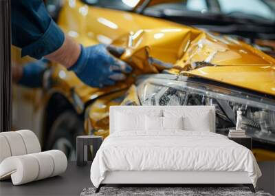 Professional auto body repair on white background after yellow car collision in modern workshop Wall mural