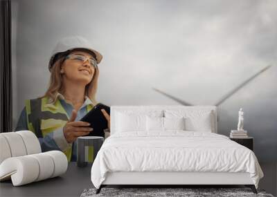 A skilled female engineer is overseeing a vital renewable energy project at a large wind farm, focusing on sustainability initiatives and promoting environmental best practices in the industry Wall mural