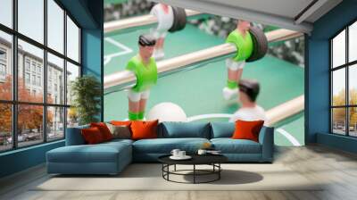 Foosball with a white ball two players fight against each other green and white Wall mural