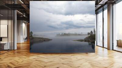 The bay, surrounded on two sides, rocky shores. In the distance, through heavy fog, you can see the neighboring island and access to the lake. Lead heavy sky. Wall mural