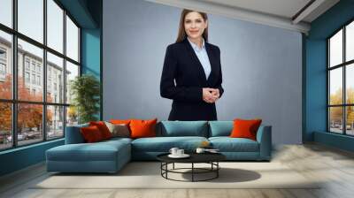 business woman wearing black suit isolated studio portrait. Wall mural