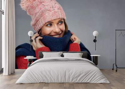 close up face portrait of smiling woman wearing winter warm clothes. Wall mural