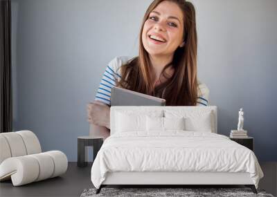 Happy student girl in white dress with stripes holding book. isolated portrait. Wall mural