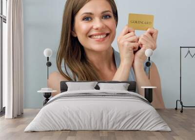 Happy woman holding credit card Wall mural