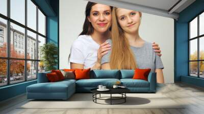 Isolated portrait of young mother with daughter. Wall mural