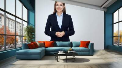 Smiling young business woman wearing black suit Wall mural