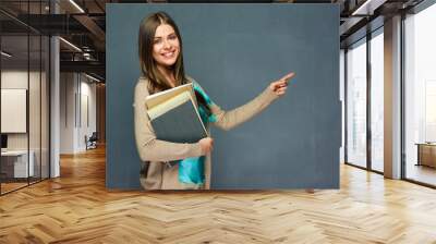 Toothy smiling girl student holding books Wall mural