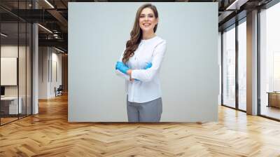 woman doctor in medical uniform standing with crossed ams wearing blue glow Wall mural