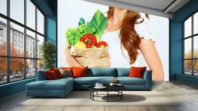 woman hold shopping bag with green vegan food Wall mural