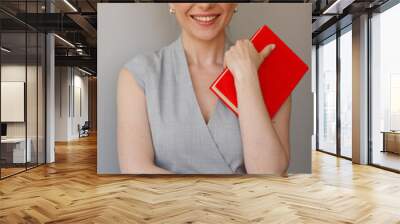 Woman teacher with red book. Isolated person portrait. Wall mural