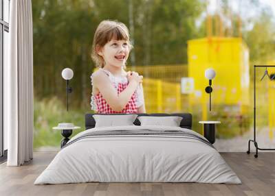 6-year-old girl looks at the sky, raising his hand to shoulder Wall mural