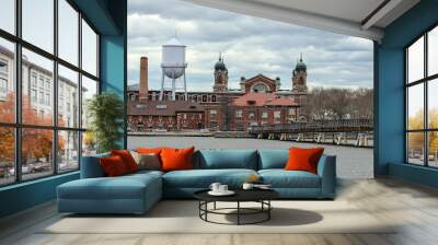 ellis island view with bridge and hudson river (from liberty state park in jersey city nj) new immigrant arrival museum historical site dark dramatic sky cloudy (york history immigration europe) Wall mural