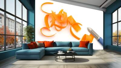 Carrot shavings and peeler knife on white background Wall mural