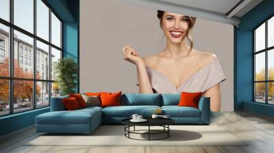 Portrait of attractive smiling woman in evening dress. Gray background. Wall mural