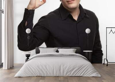 Portrait of young man in black shirt gesturing ok sign against w Wall mural