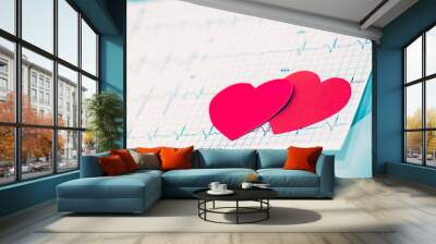  health concept: two red paper heart on the electrocardiogram, the cardiologist. Wall mural