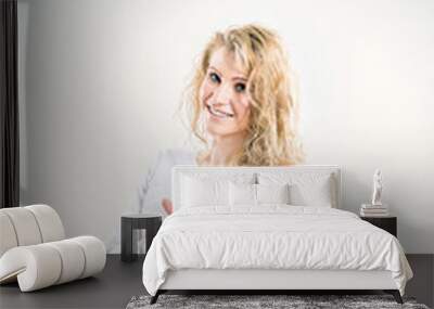 beautiful young woman blonde in t-shirt and jeans on white backg Wall mural