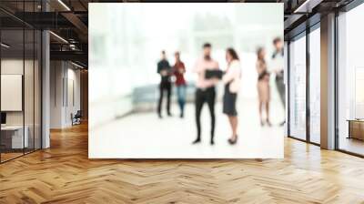 blurred image of a group of business people talking in the office lobby. photo with copy space Wall mural