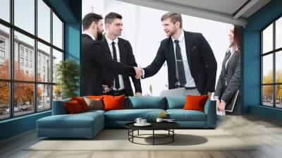 business woman greets the employee with a handshake, Wall mural