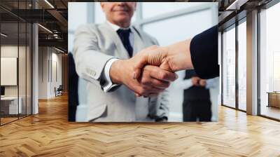 businessman confidently shaking hands with his business partner. Wall mural