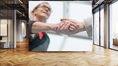 close up. confident business people shaking hands with each other Wall mural