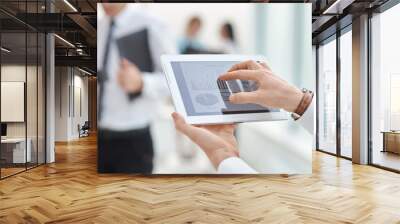 close up. the businessman uses a digital tablet to check financial data. Wall mural