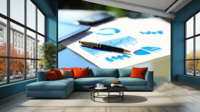 Financial charts on the table with tablet and pen Wall mural