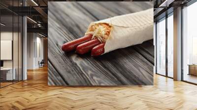 German sausages in pita bread on a dark wooden background.photo  Wall mural