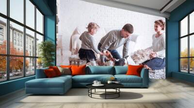 happy family playing with a pet dog in the spacious living room Wall mural