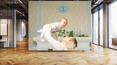 happy family. a young mother plays with her young child . positi Wall mural