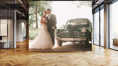 newlyweds standing on the side of the road Wall mural