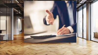 Portrait of a successful businessman giving a hand Wall mural