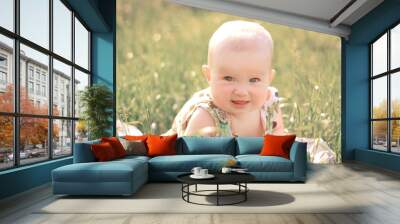 portrait of pretty baby on the lawn on a summer day Wall mural