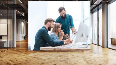 smiling employees checking financial statements . business concept Wall mural